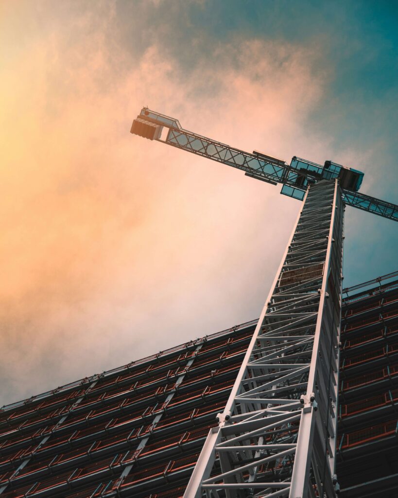 Tower crane against a vivid sunset sky — video deliverables for construction companies