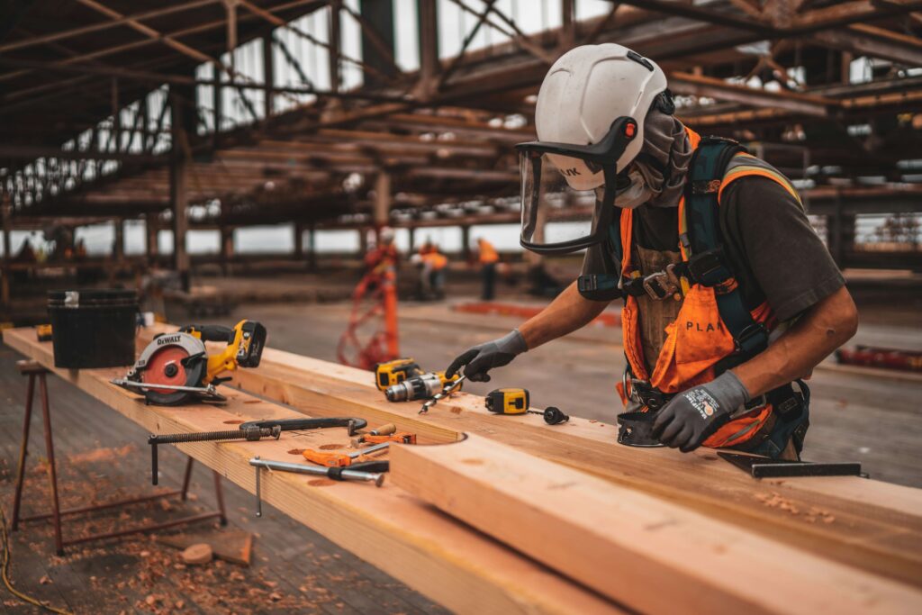 Construction worker in hard hat inside a steel structure — construction video production