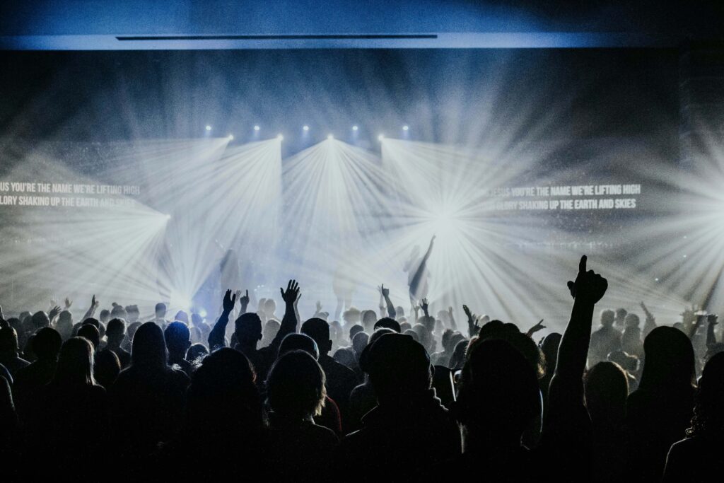 Celebration crowd with stage lights at a grand opening event, captured for new distribution center launch marketing