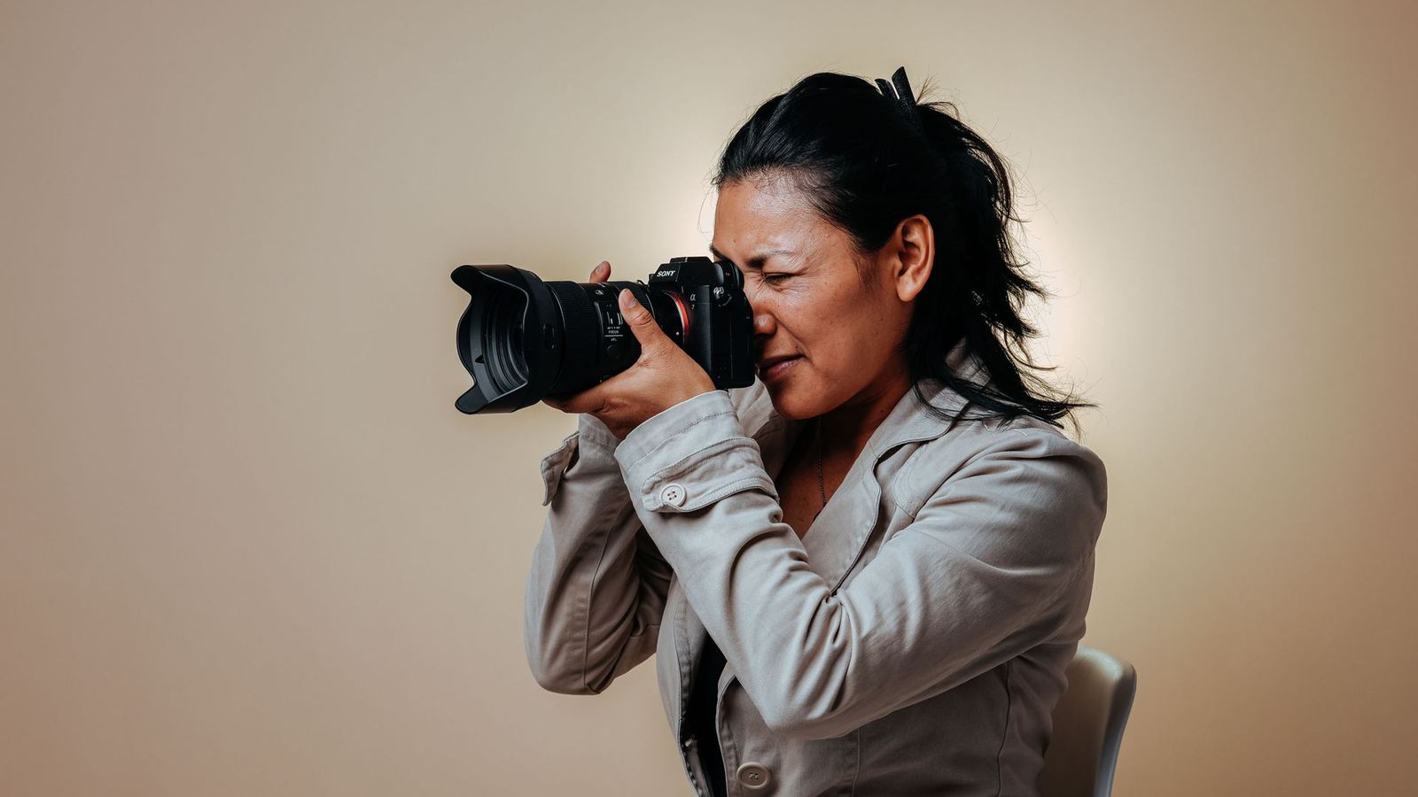 Photographer taking a corporate headshot during a company portrait session