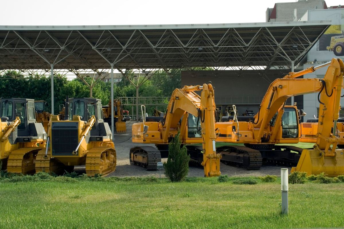 Construction vehicles parked in an outdoor equipment yard