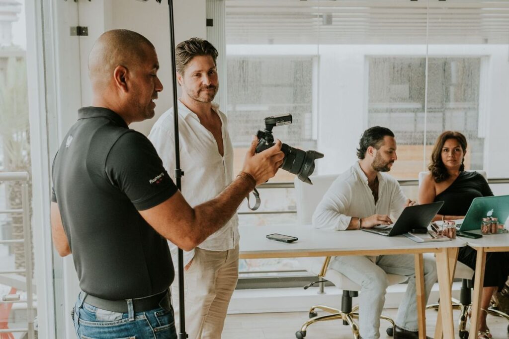 Photographer taking a portrait of an employee during a company headshot session in an office