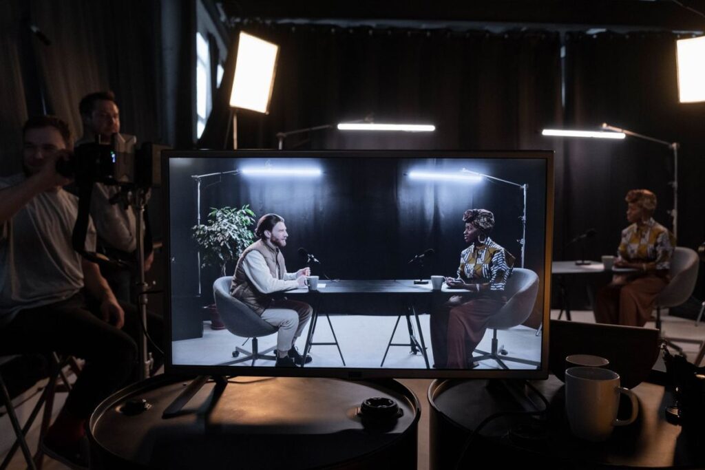 Studio recording of a training video, shown on a monitor during filming