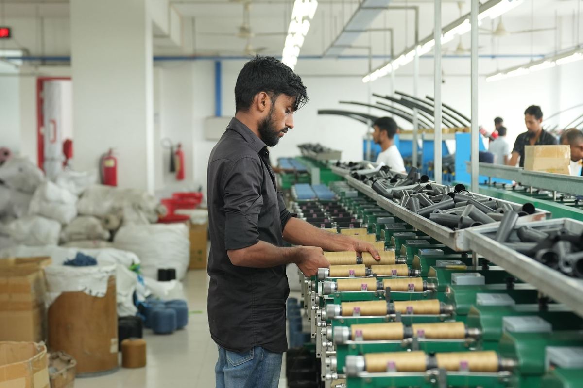 Employee operating equipment on a factory floor
