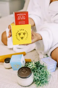 Savannah Bee Company product collection with honey jars and botanical elements