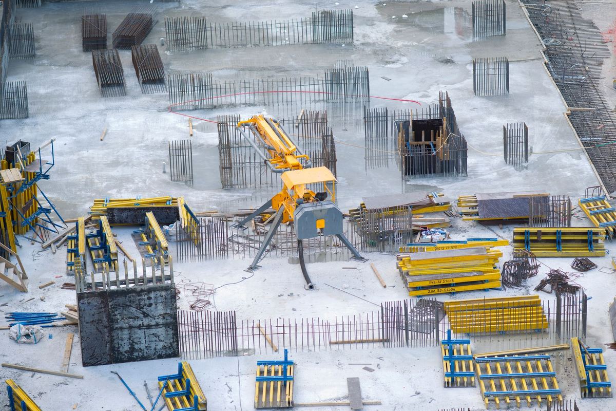 Aerial view of a snow covered construction site with rebar and equipment