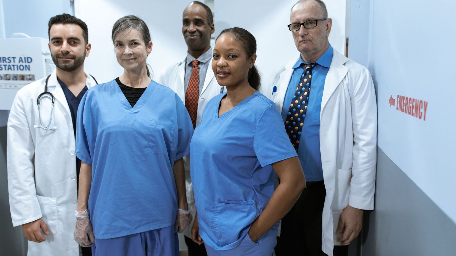 Healthcare team of doctors and nurses standing together in a hospital corridor