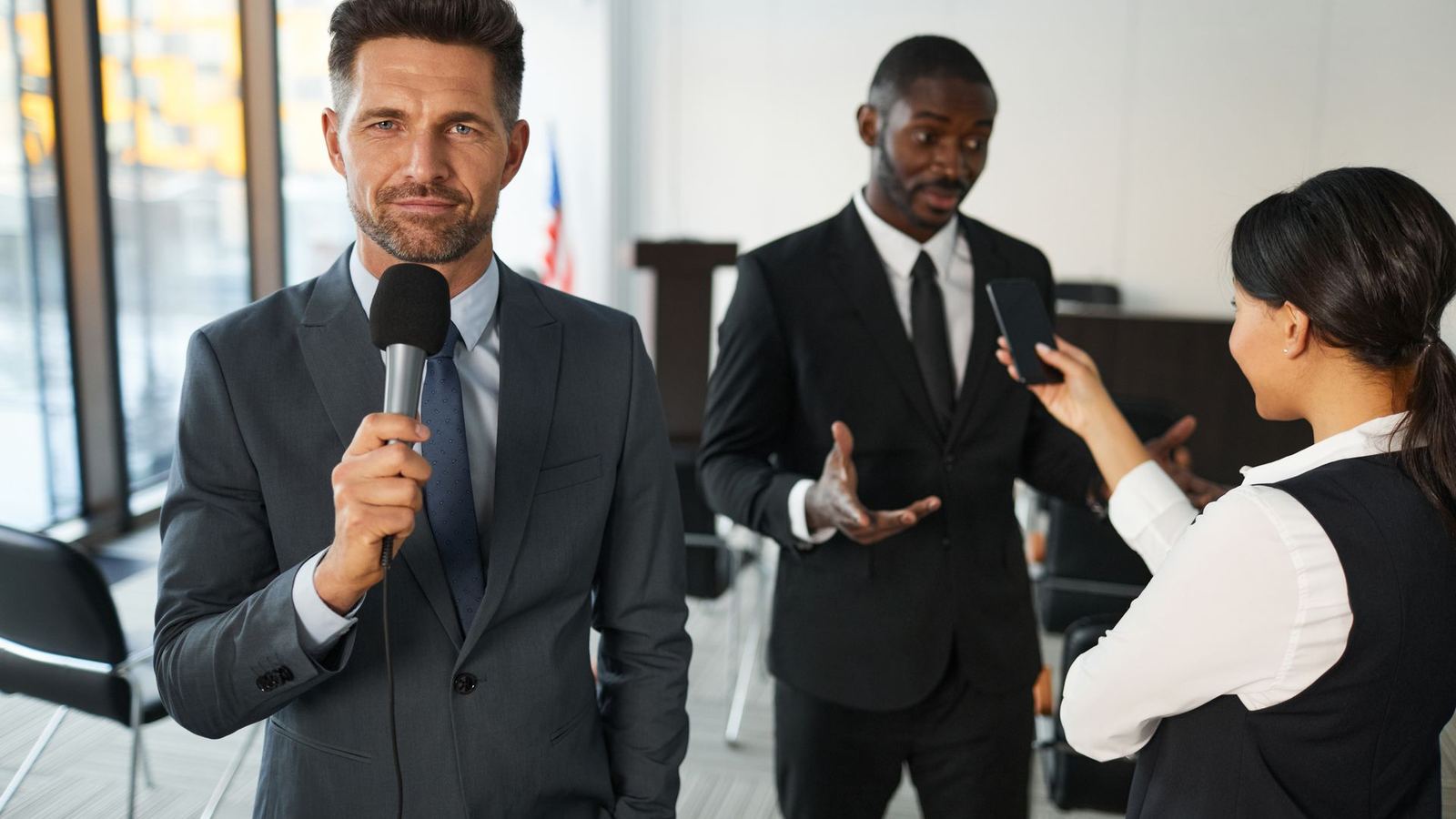 Businessman holding a microphone during an interview in a conference room