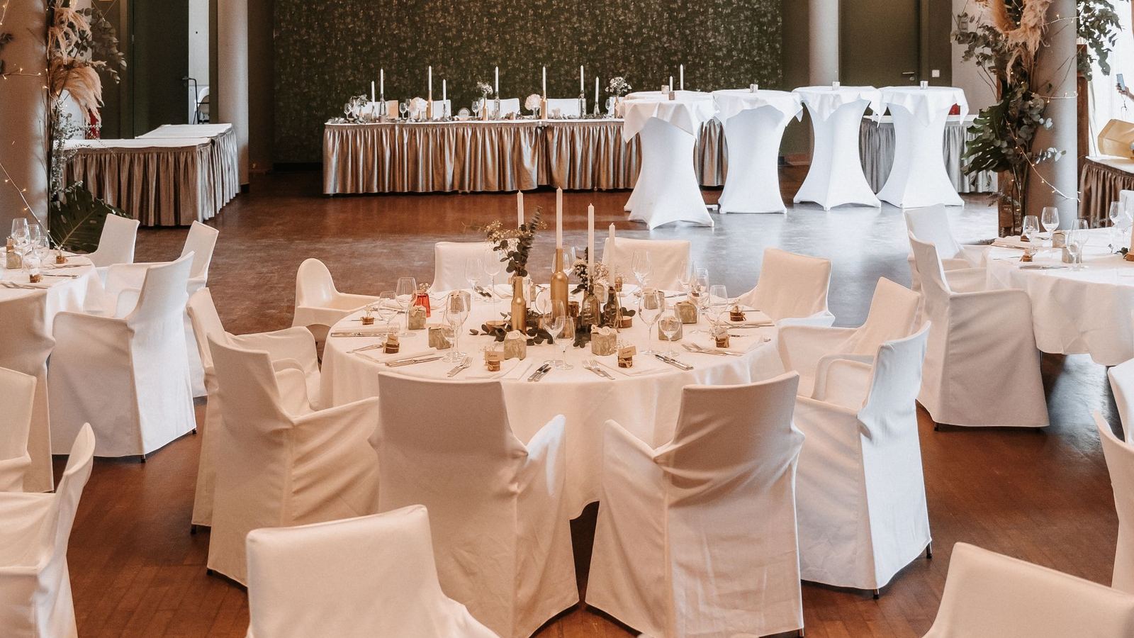 Elegant ballroom set for a wedding reception with chandeliers